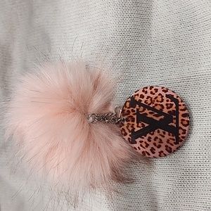 Keychain Louie Vuitton with pink fuzzy ball. Not authentic.